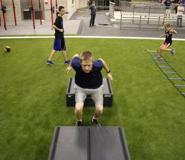 Teen jumping boxes