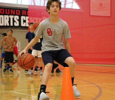 teen dribbling basketball