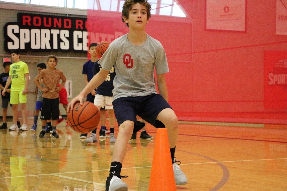teen dribbling basketball