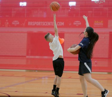 Teens playing basketball
