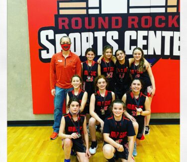 girl basketball team posing for photo