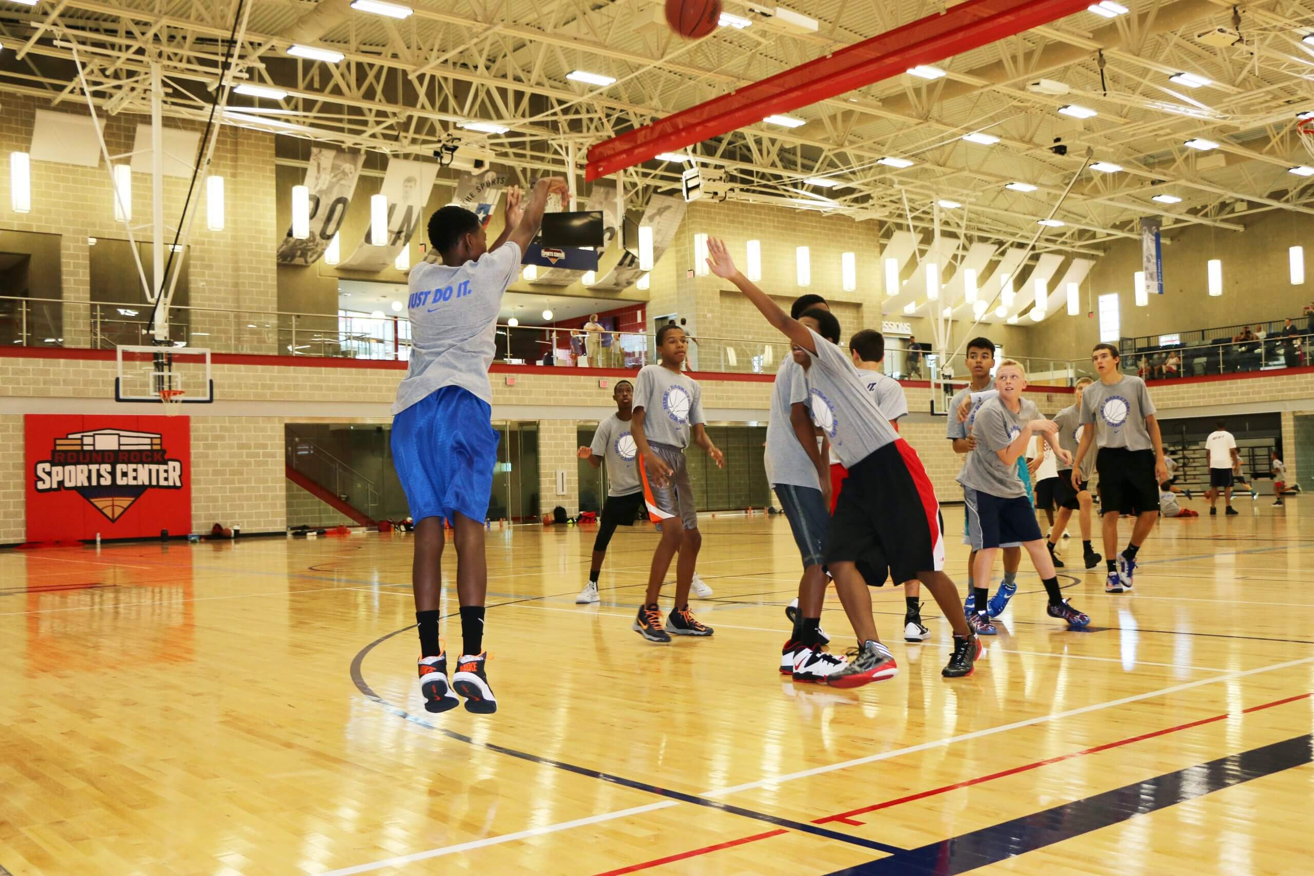 Teens shooting basketball