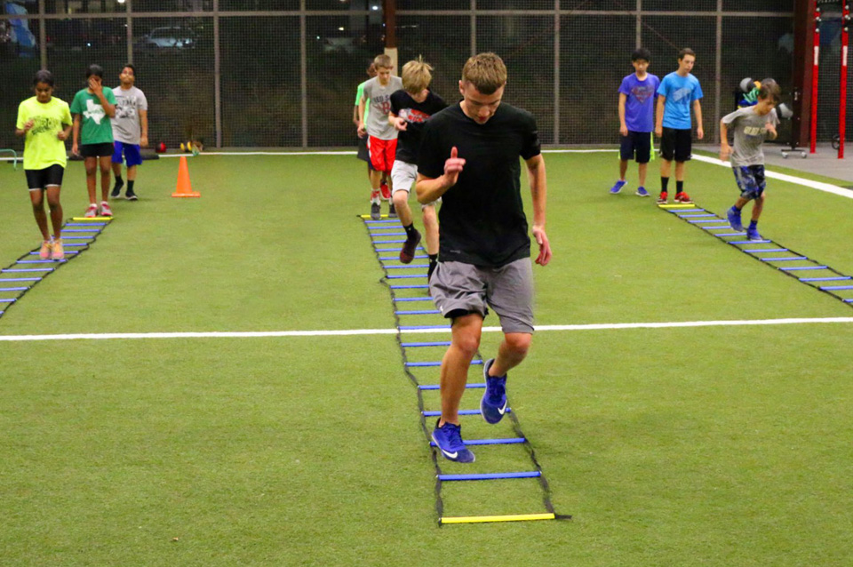 Strength & Conditioning drills with athletes running ladders