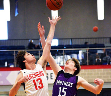 two basketball players at tip off