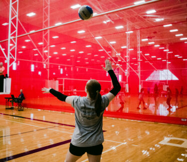 A volleyball player getting ready to serve the ball during a training program at the Round Rock Sports Center